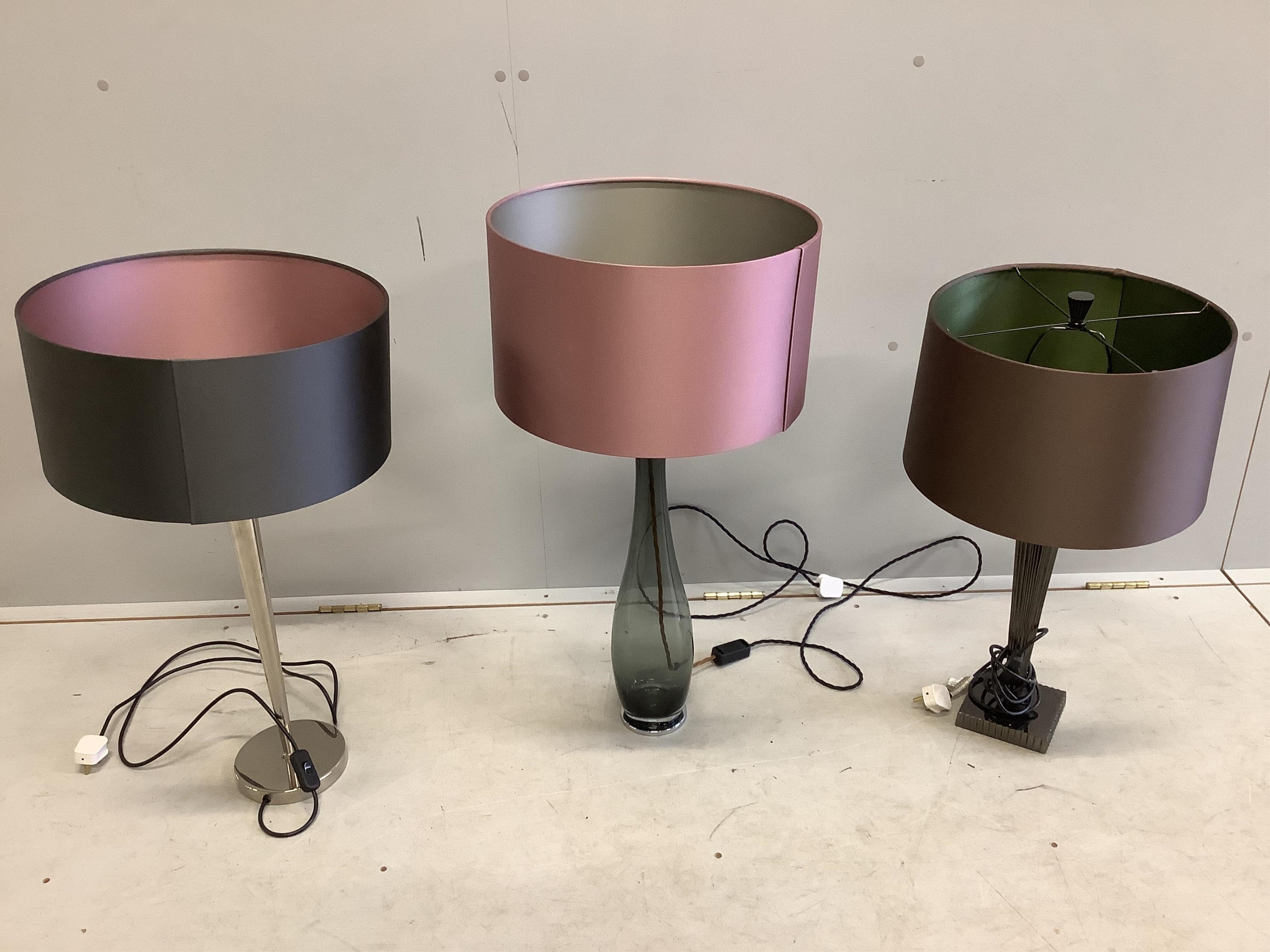 An Astley metallic pillar lamp, a Heathfield and Co. Bliss smoked glass lamp and a similar chrome lamp, all with shades, largest height 78cm. Condition - good